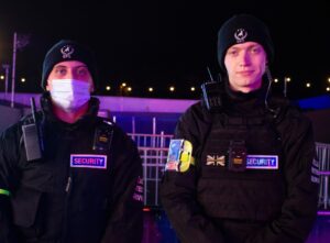 Image of two professional security operatives wearing bullet proof and stab proof vests